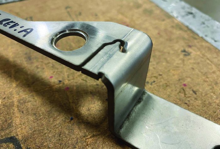 Fig. 7 -  Unslitting, silhouetting and tabbing are means to prevent deformation during bending by refraining from cutting features near the bend line during the blanking process, thus keeping the skeleton attached to the workpiece, and cutting it later.