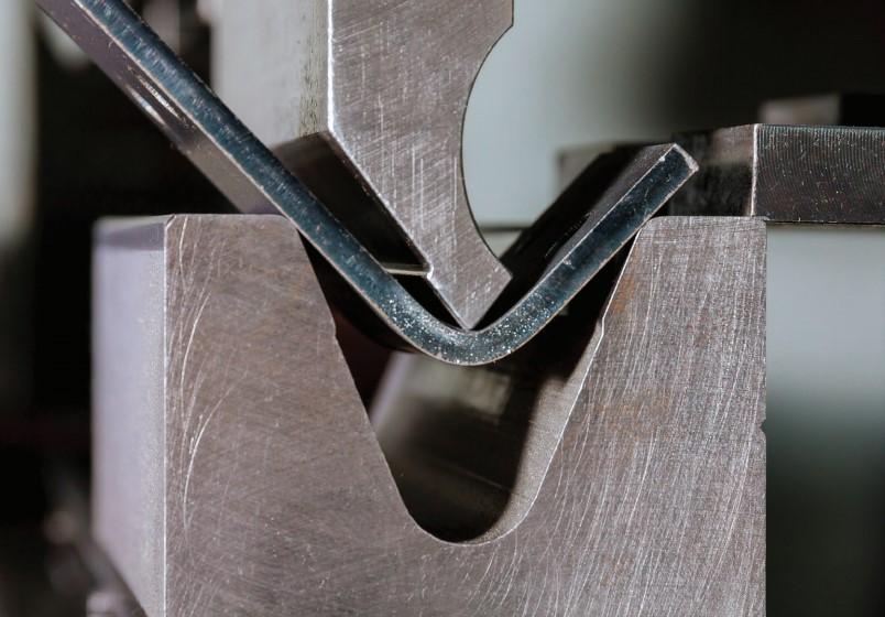 FIGURE 8 In air bending, the die opening establishes the radius and the punch's depth of penetration into the die space establishes the bend angle. This further demonstrates how crucial it is to keep the flange length at a minimum. This bend might not fit firmly on the die if it were nearer the plate edge.